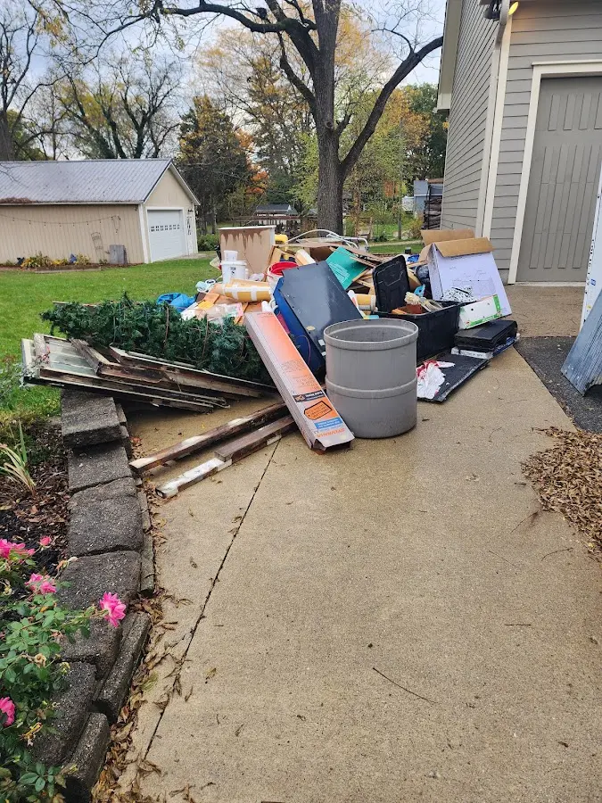 Dumpster being loaded with debris for Roofing Dumpster Rental in Wildwood